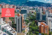 Airbnb y el POT de Medellín: ¿busca incidir en la política de rentas cortas? Panorámica de El Poblado, Medellín, con el logo de Airbnb superpuesto.